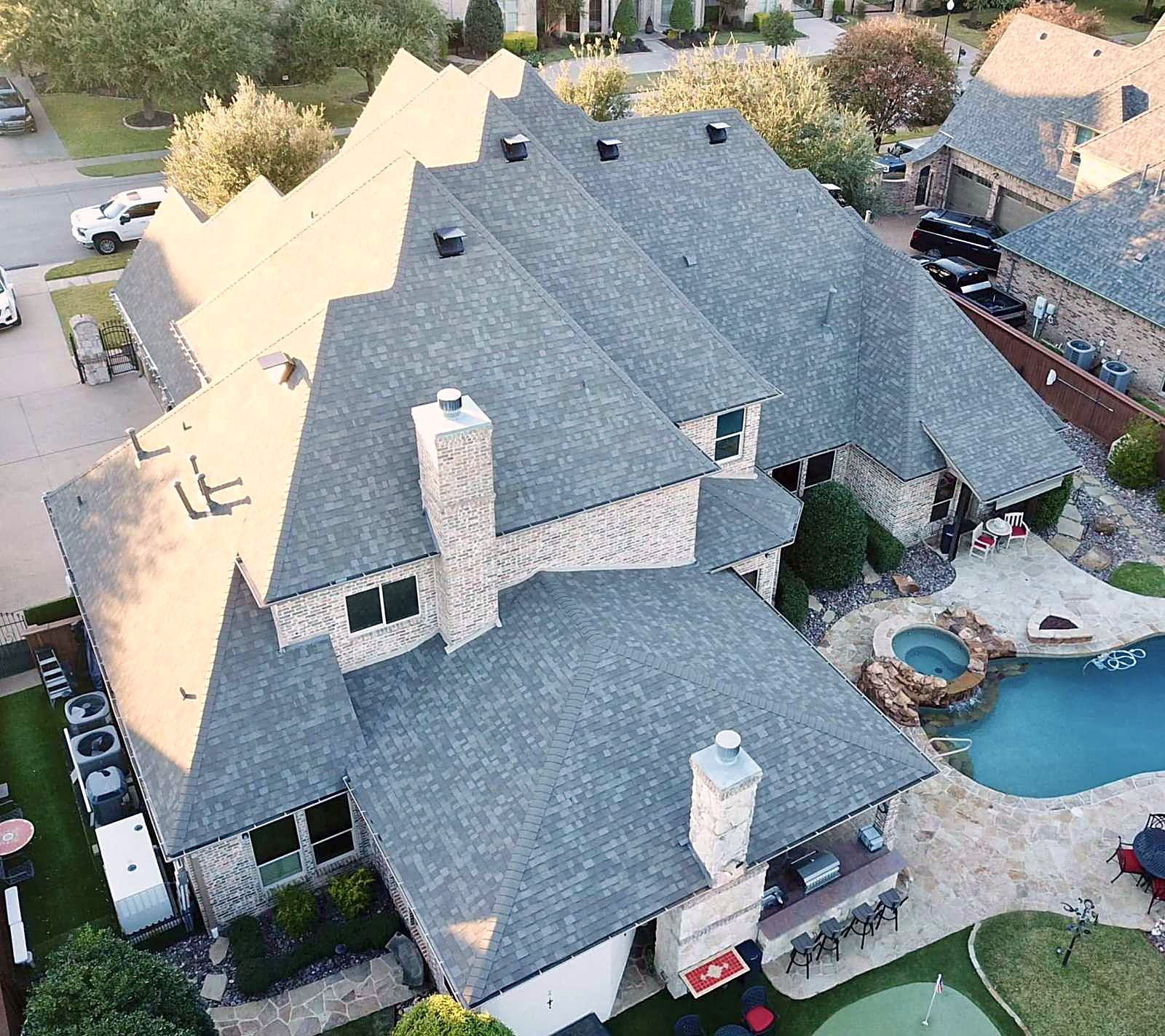 A Honey Bees reroof photographed from above, the finished shingle running across every slope